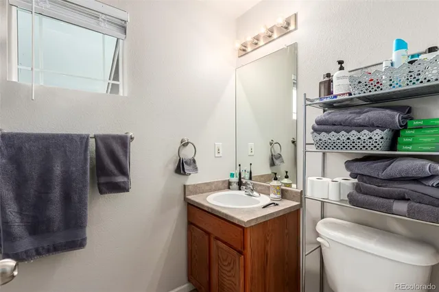 a bathroom with a sink toilet and mirror