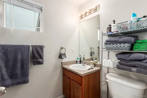 a bathroom with a sink toilet and mirror