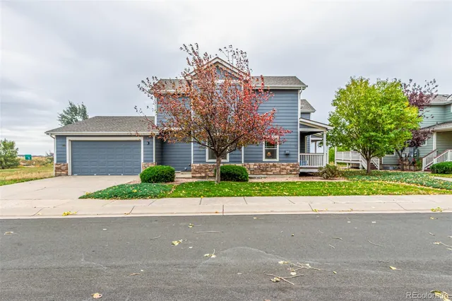 a front view of house with a yard and trees