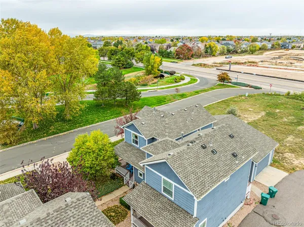 an aerial view of a house with a garden and lake view