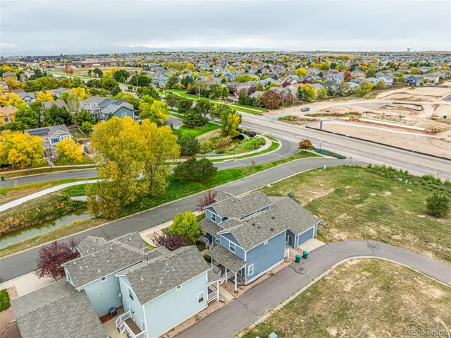 an aerial view of residential houses with outdoor space