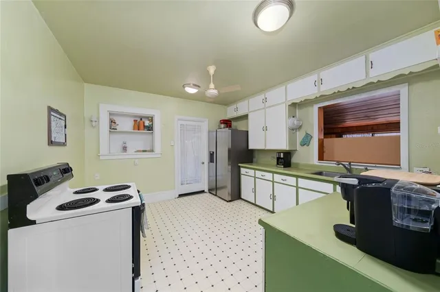 a kitchen with a sink cabinets and window