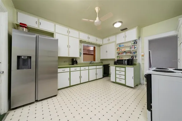 a kitchen with stainless steel appliances a refrigerator sink and stove