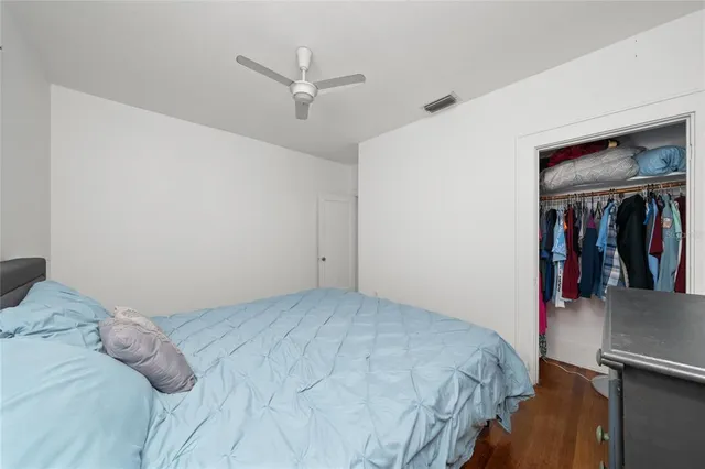 a bedroom with a bed and a view of closet