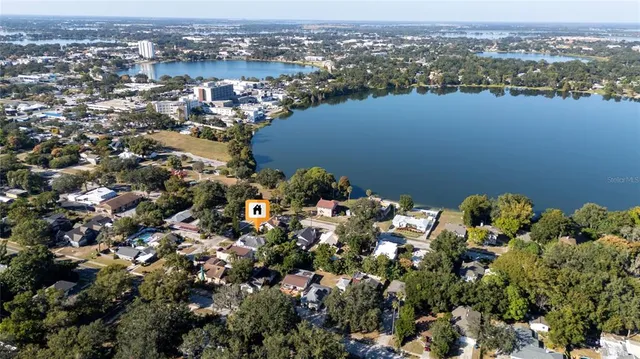 an aerial view of a houses with a lake