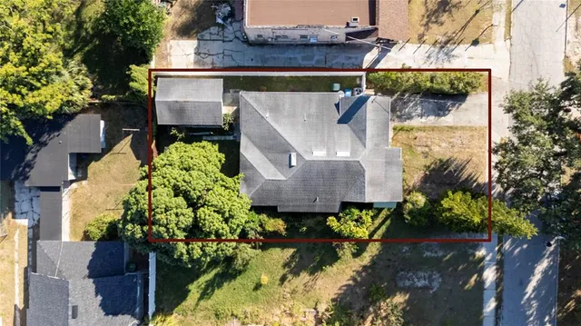 an aerial view of a house with a yard and garden