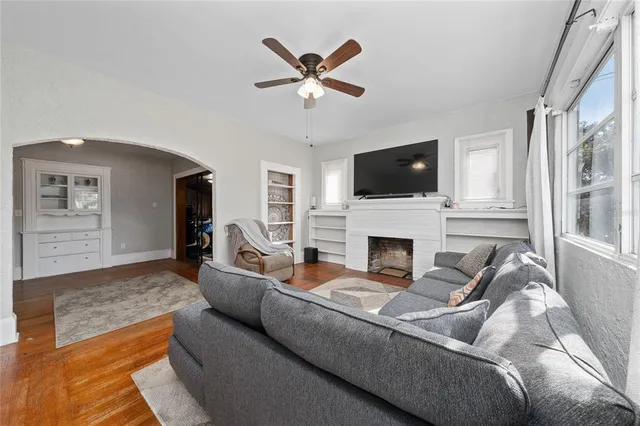 a living room with furniture a fireplace and a flat screen tv