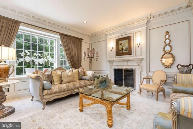 a living room with furniture a fireplace and a window