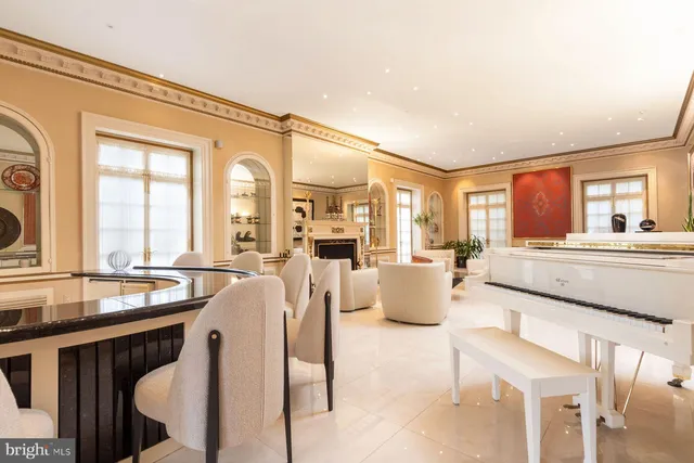 a dining room with furniture and a large window