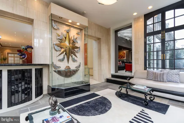 a living room with furniture a rug and a window