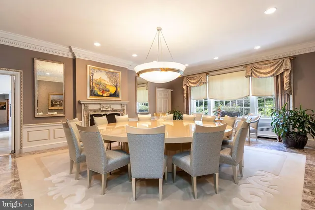 a dining room with furniture a chandelier and window