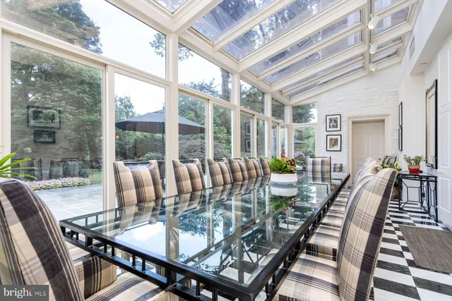 a view of a dining room with furniture a chandelier and wooden floor