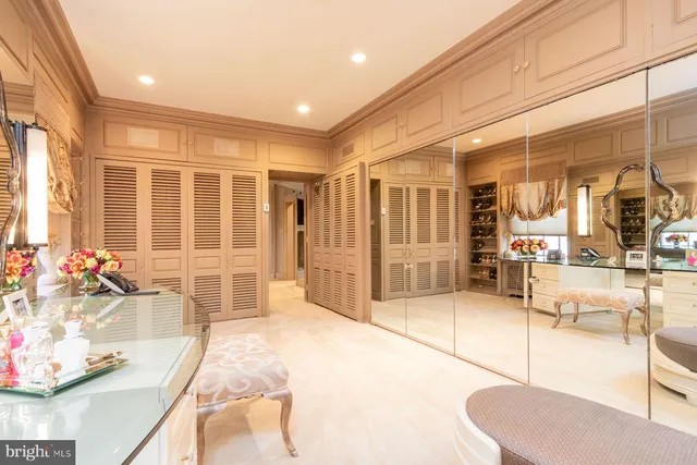 a spacious bedroom with a balcony a bed and a large window