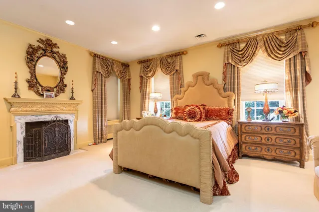 a bedroom with a bed and a fireplace