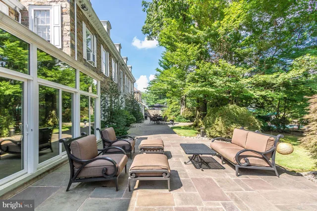 a view of a patio with a table and chairs and couches
