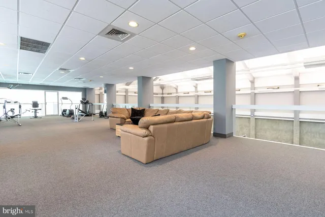 a room with gym equipment and a large window