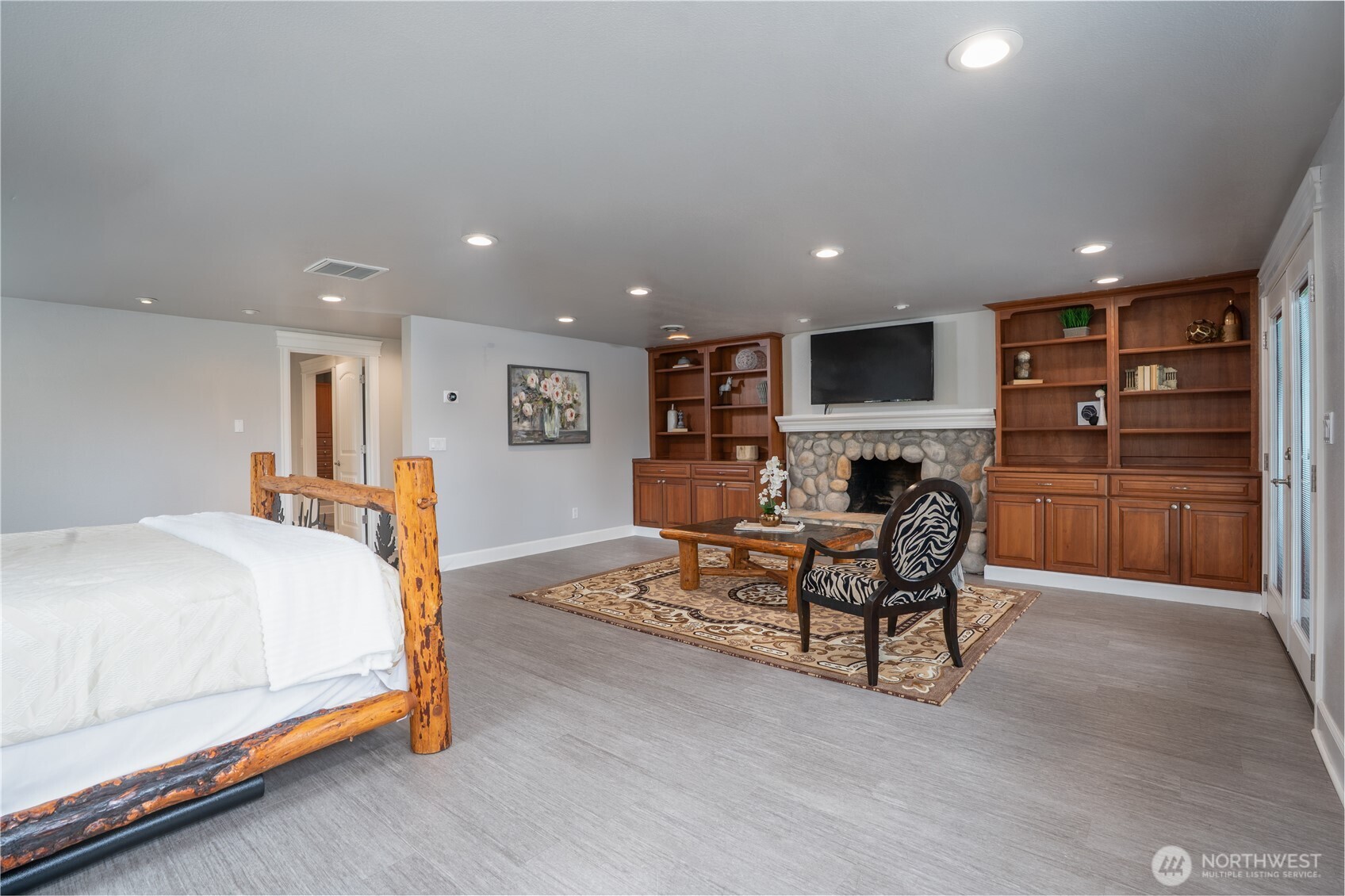 30815 Webster Road East Eatonville, WA 98328 - Photo 11 of 40 a spacious bedroom with a bed and a couch