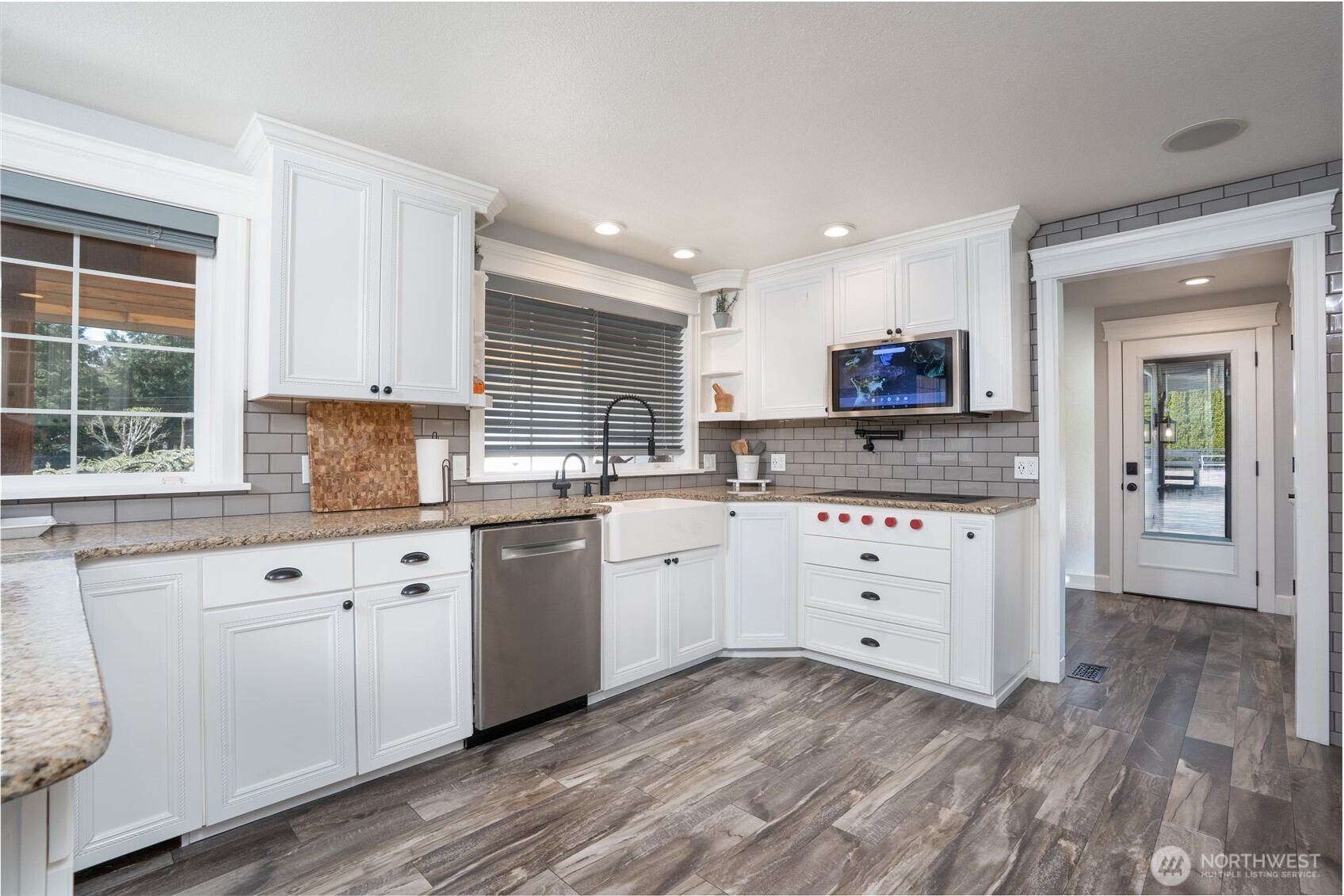 30815 Webster Road East Eatonville, WA 98328 - Photo 7 of 40 a kitchen with granite countertop white cabinets white appliances a sink and a window