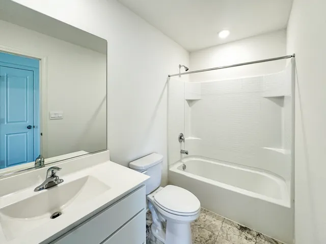 a bathroom with a sink a toilet and a bathtub