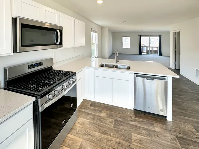 a kitchen with a stove and a microwave