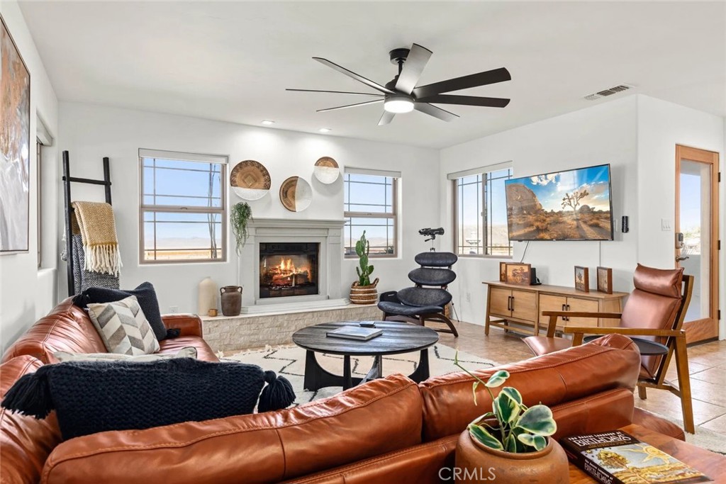 7030 Mile Square Road Joshua Tree, CA 92252 - Photo 12 of 58 a living room with furniture and a fireplace