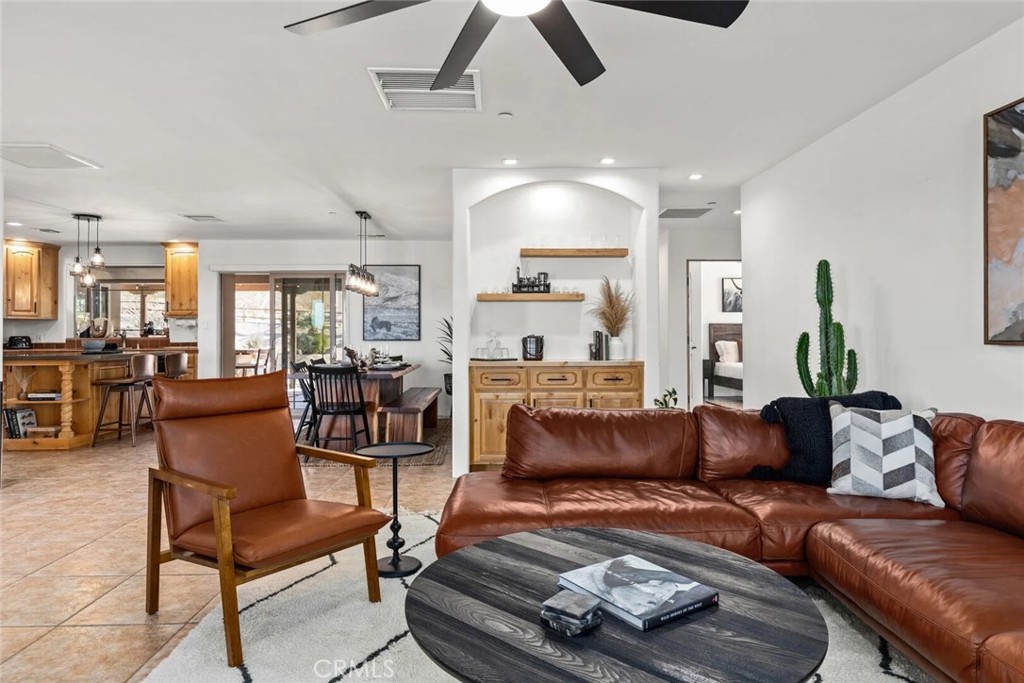 7030 Mile Square Road Joshua Tree, CA 92252 - Photo 14 of 58 a living room with furniture and a view of kitchen