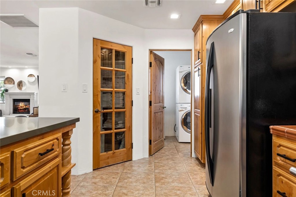7030 Mile Square Road Joshua Tree, CA 92252 - Photo 20 of 58 a view of a kitchen with a sink and a refrigerator
