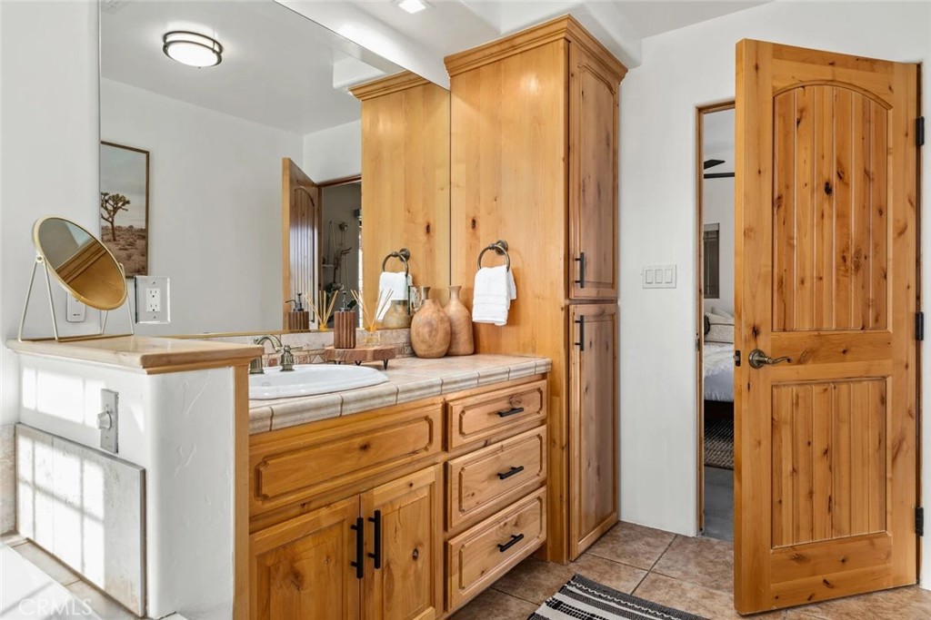 7030 Mile Square Road Joshua Tree, CA 92252 - Photo 25 of 58 a bathroom with a double vanity sink mirror and double