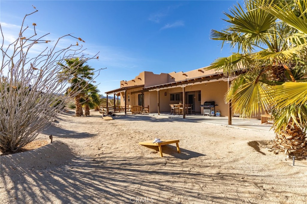 7030 Mile Square Road Joshua Tree, CA 92252 - Photo 3 of 58 a swimming pool with outdoor seating and yard
