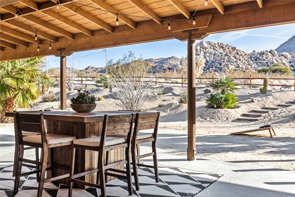 7030 Mile Square Road Joshua Tree, CA 92252 - Photo 4 of 58 a view of a chairs and table in the patio