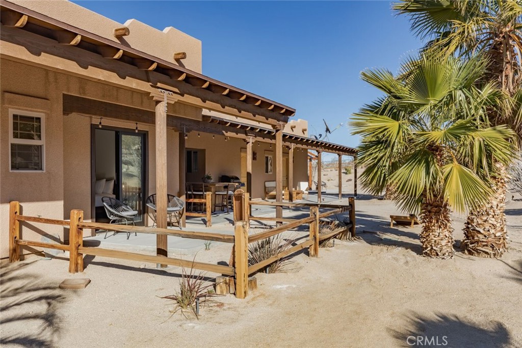 7030 Mile Square Road Joshua Tree, CA 92252 - Photo 48 of 58 front view of the house with a patio