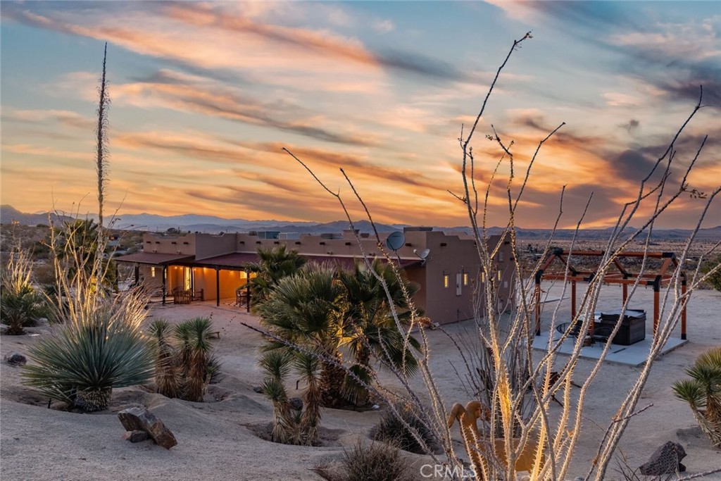 7030 Mile Square Road Joshua Tree, CA 92252 - Photo 5 of 58 a view of a house with a tree