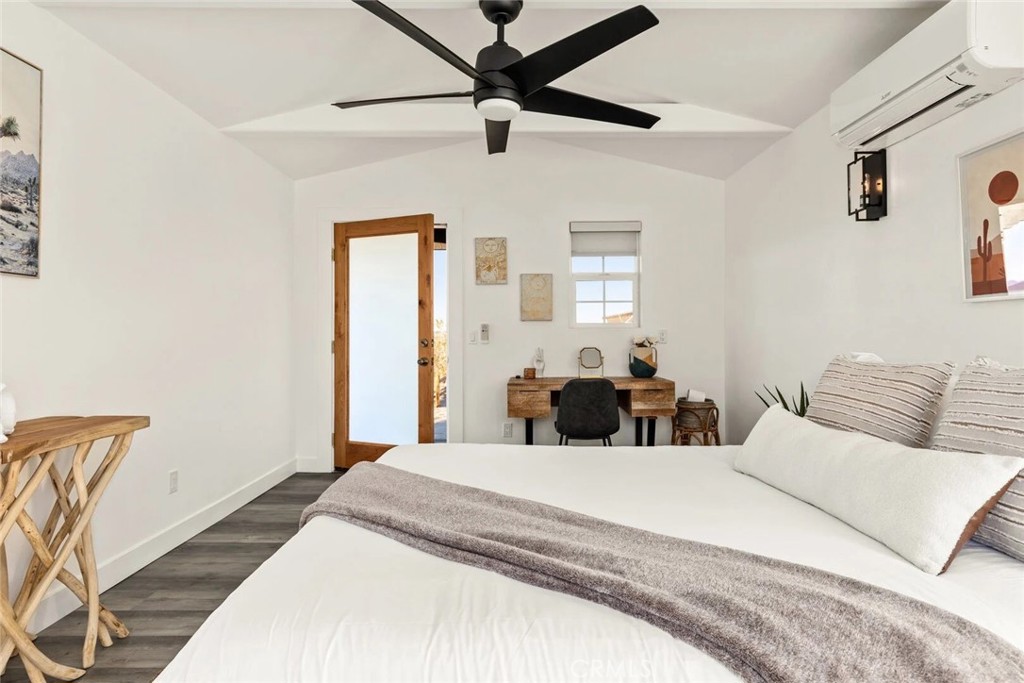 7030 Mile Square Road Joshua Tree, CA 92252 - Photo 56 of 58 a bedroom with a bed and window