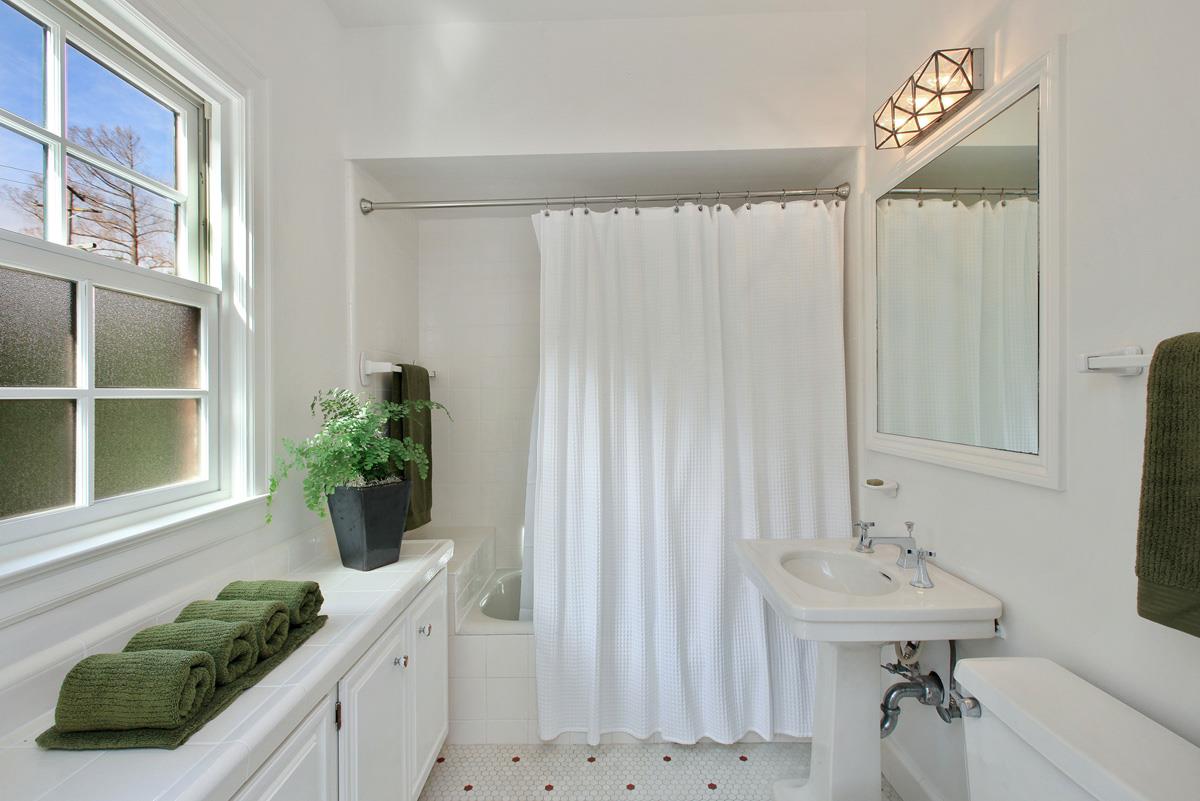 973 Baileyana Road Hillsborough, CA 94010 - Photo 17 of 35 a bathroom with a sink a potted plant and a window