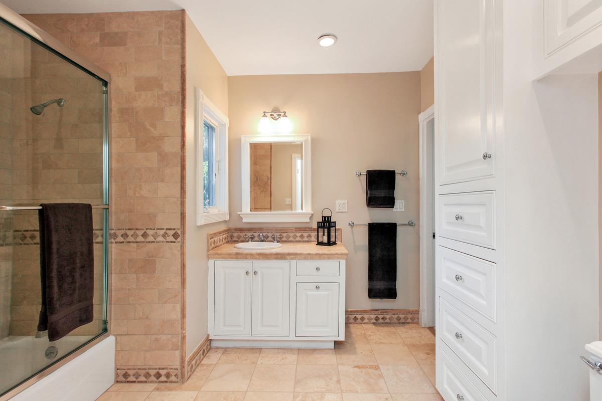 973 Baileyana Road Hillsborough, CA 94010 - Photo 22 of 35 a bathroom with a double vanity sink toilet and shower