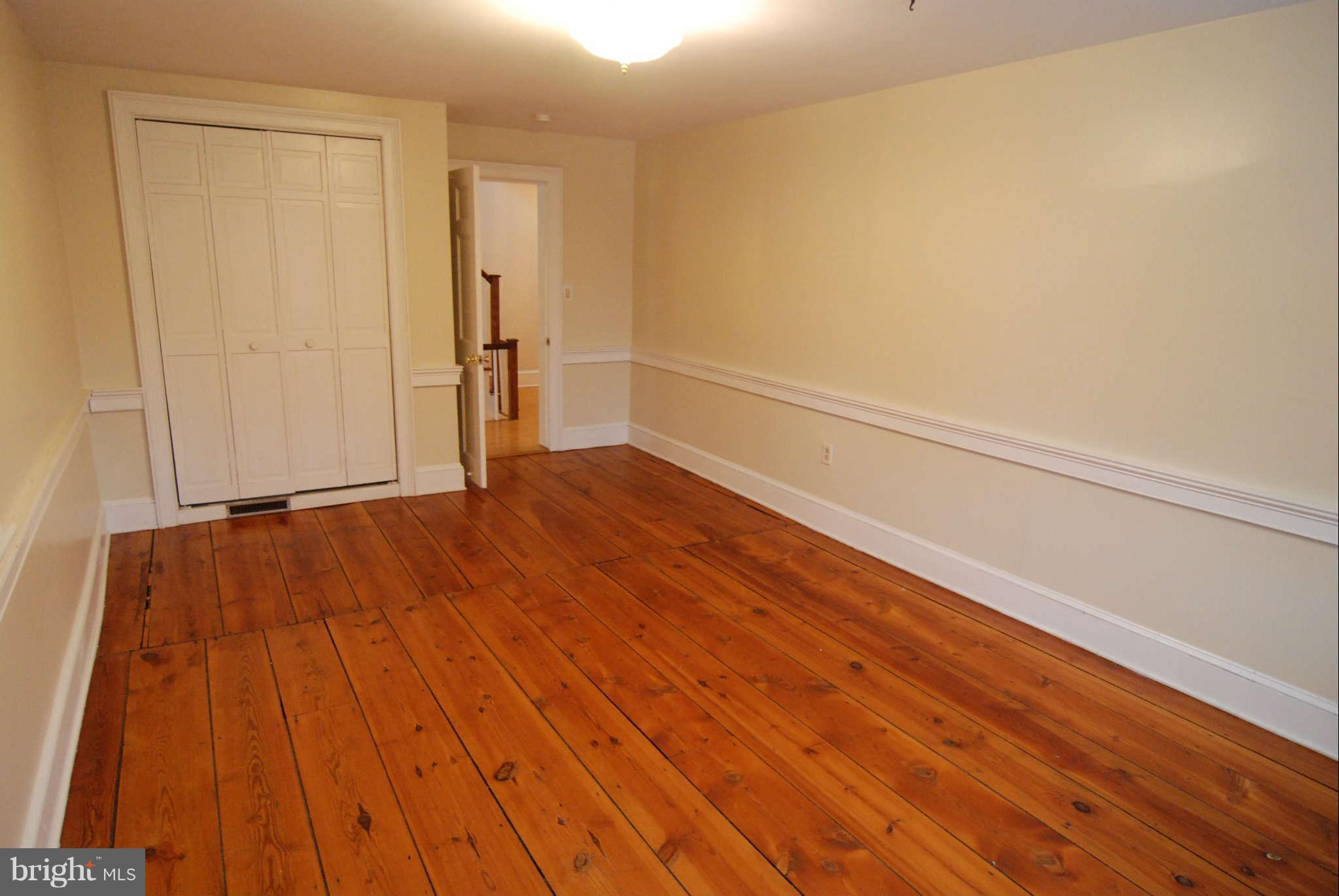 12516 Big Pool Road Clear Spring, MD 21722 - Photo 14 of 30 a view of an empty room with wooden floor and a window