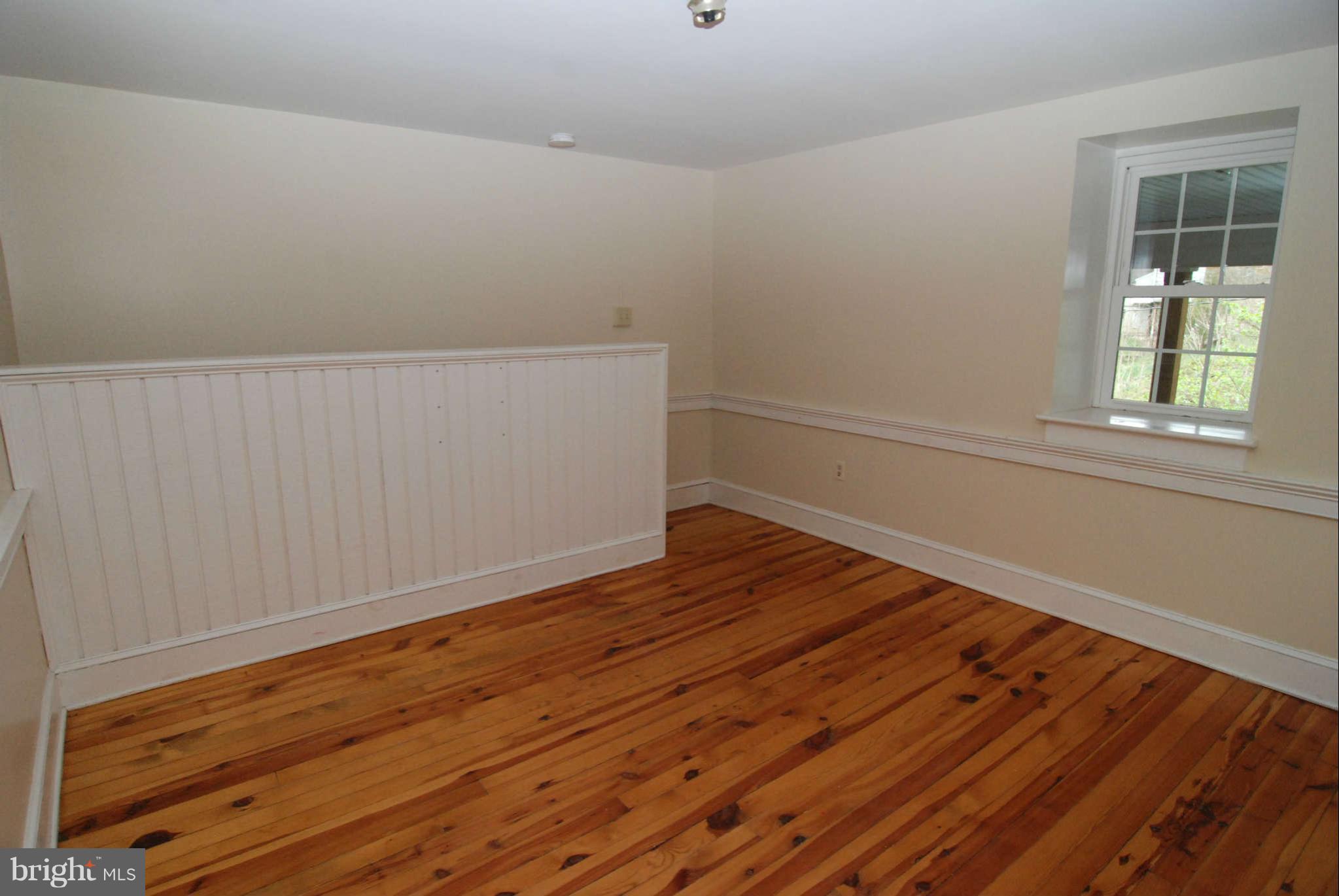 12516 Big Pool Road Clear Spring, MD 21722 - Photo 15 of 30 a view of an empty room with wooden floor and a window