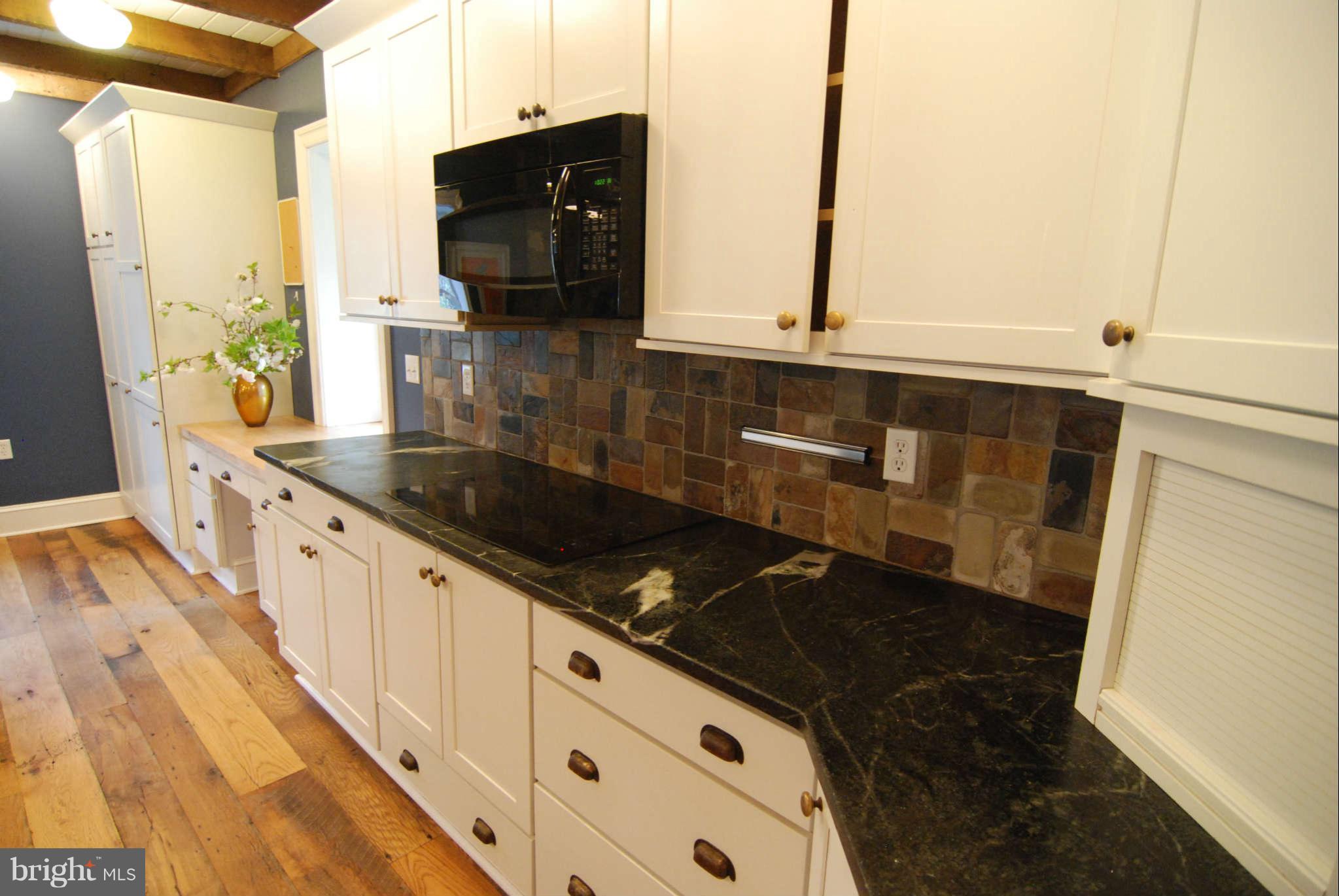 12516 Big Pool Road Clear Spring, MD 21722 - Photo 7 of 30 a kitchen with granite countertop a sink and a stove