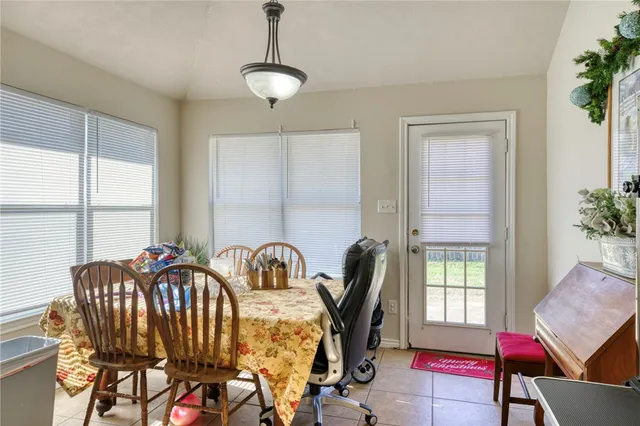 a view of a dining room with furniture and window