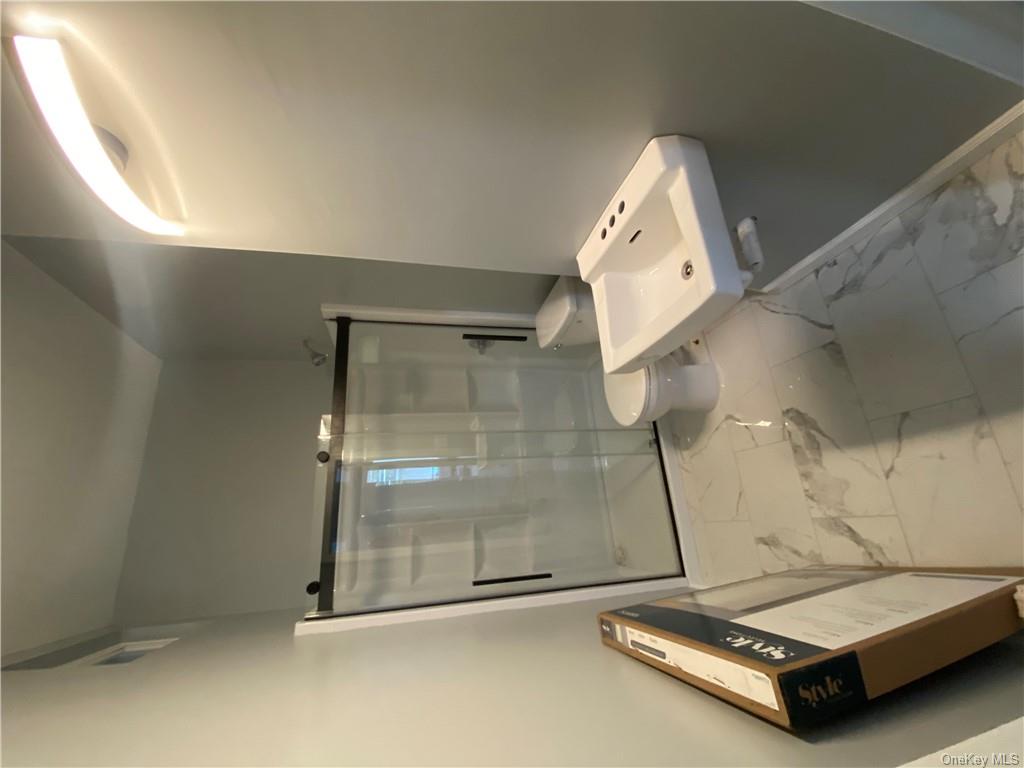 117 North Street, Unit 2 Middletown, NY 10940 - Photo 2 of 5 a bathroom with a sink toilet and shower