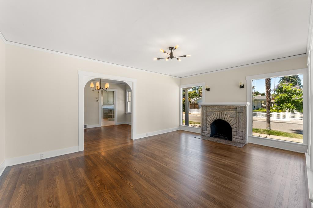 395 Loreto Street Mountain View, CA 94041 - Photo 4 of 28 a view of an empty room with wooden floor fireplace and a window