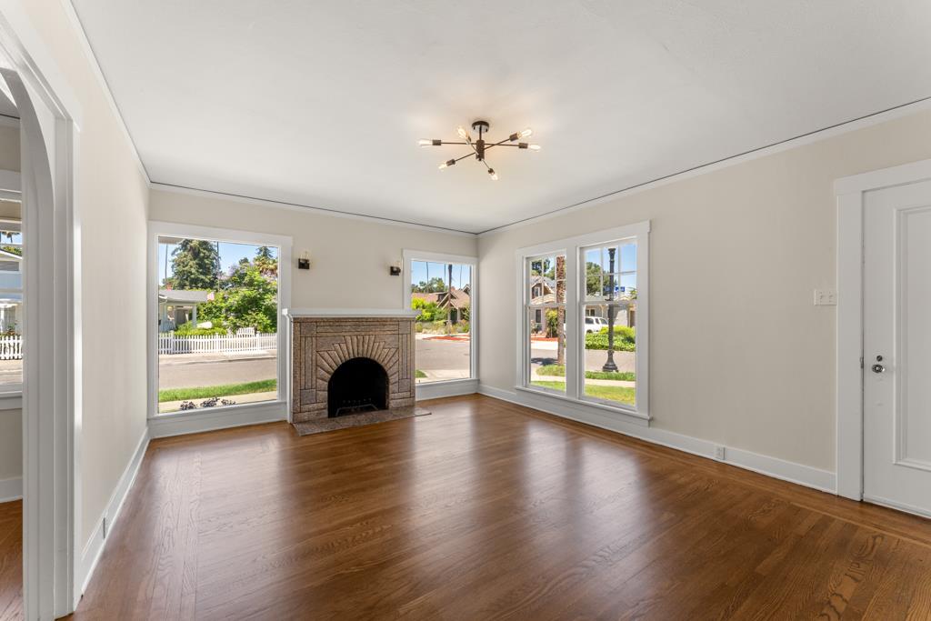 395 Loreto Street Mountain View, CA 94041 - Photo 5 of 28 an empty room with fireplace wooden floor and windows