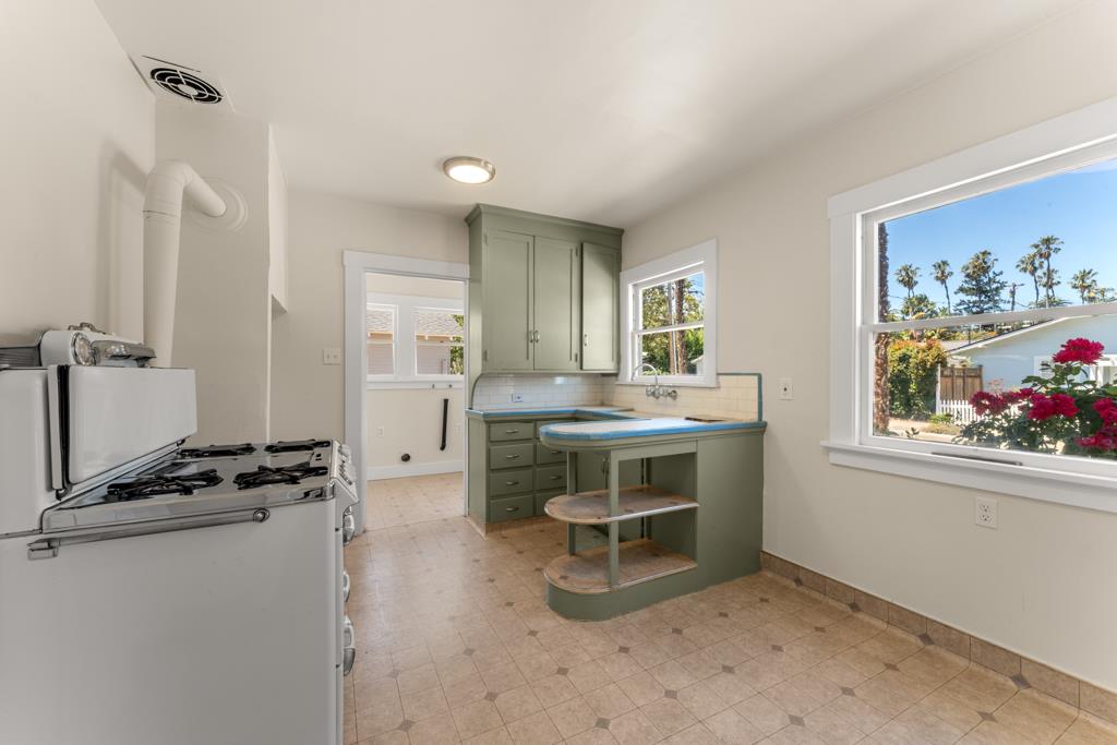 395 Loreto Street Mountain View, CA 94041 - Photo 10 of 28 a kitchen with a refrigerator and a stove top oven