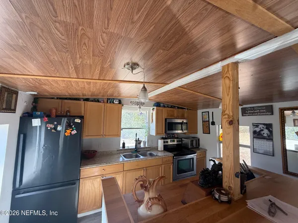 a kitchen with stainless steel appliances granite countertop a refrigerator and a stove