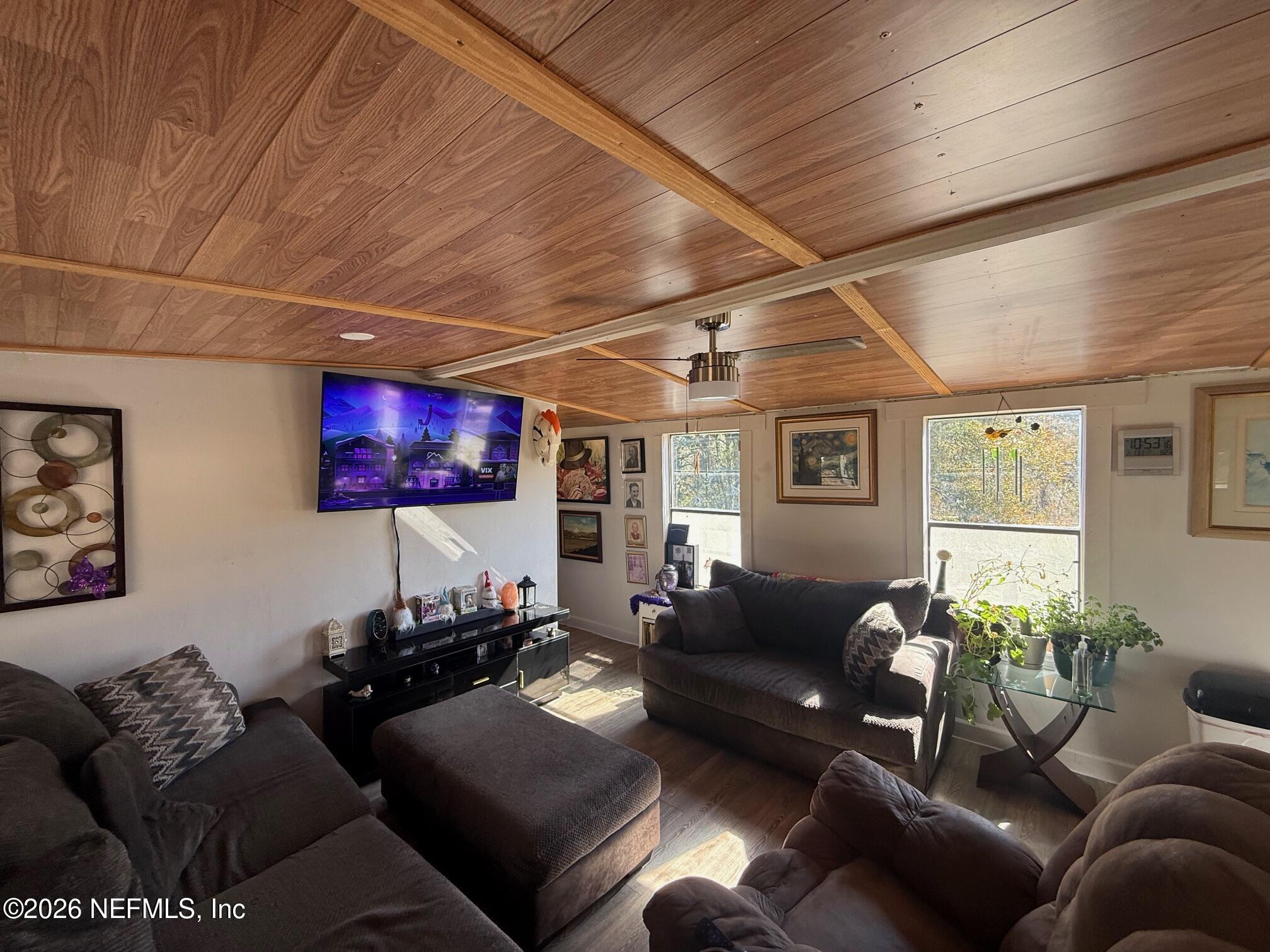 104 Churchill Street Interlachen, FL 32148 - Photo 15 of 24 a living room with furniture and a flat screen tv