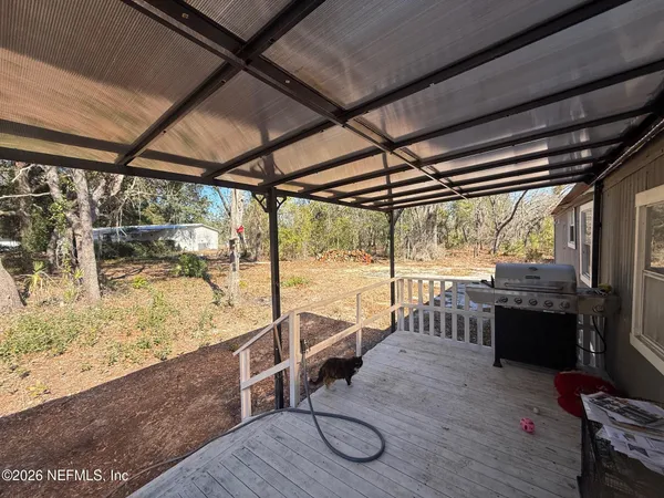a view of a porch with furniture and wooden floor
