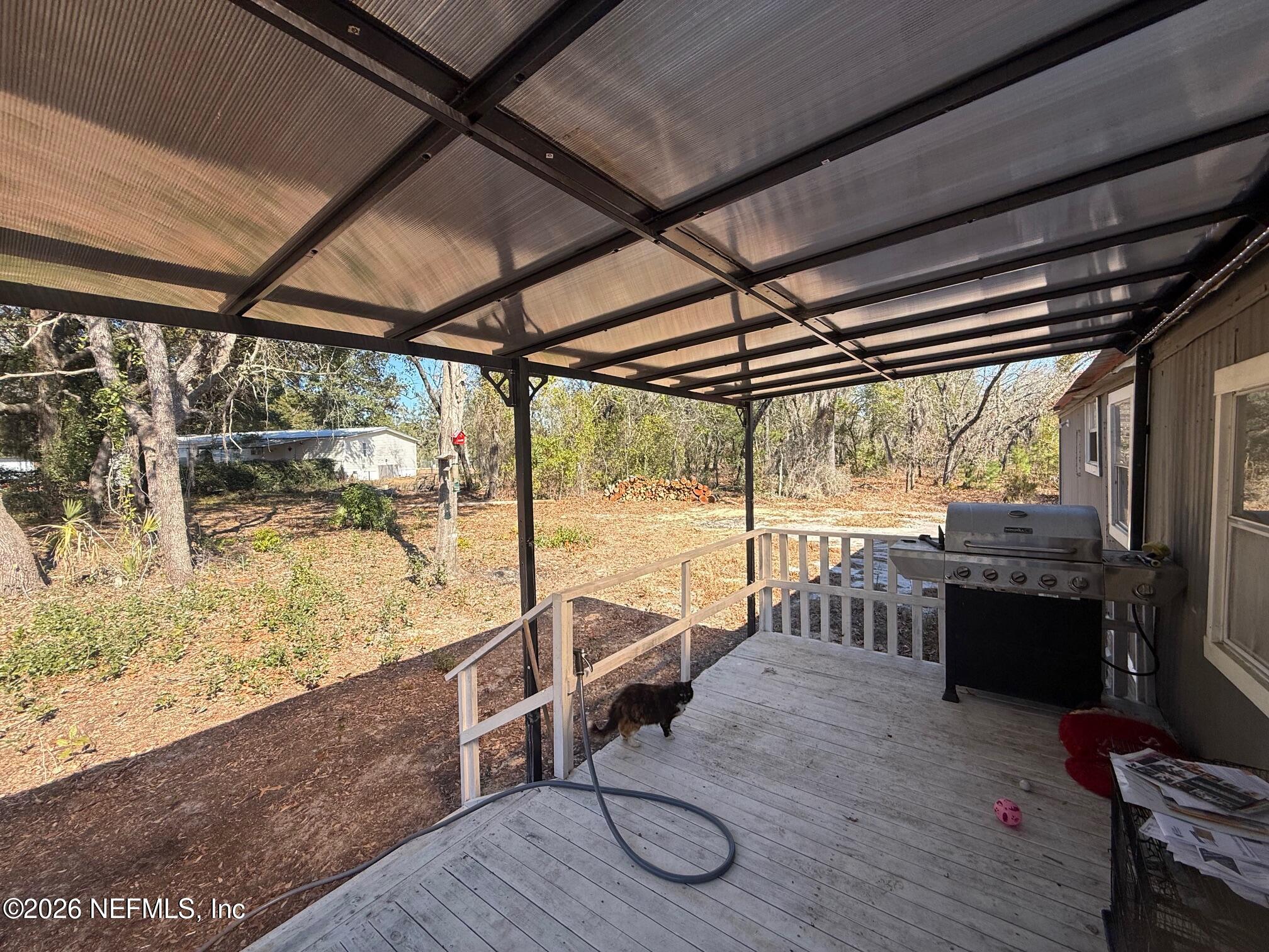 104 Churchill Street Interlachen, FL 32148 - Photo 19 of 24 a view of a porch with furniture and wooden floor