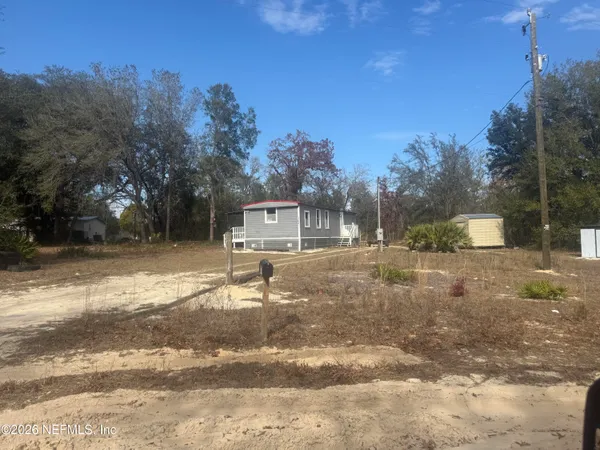 a backyard of a house with table and chairs