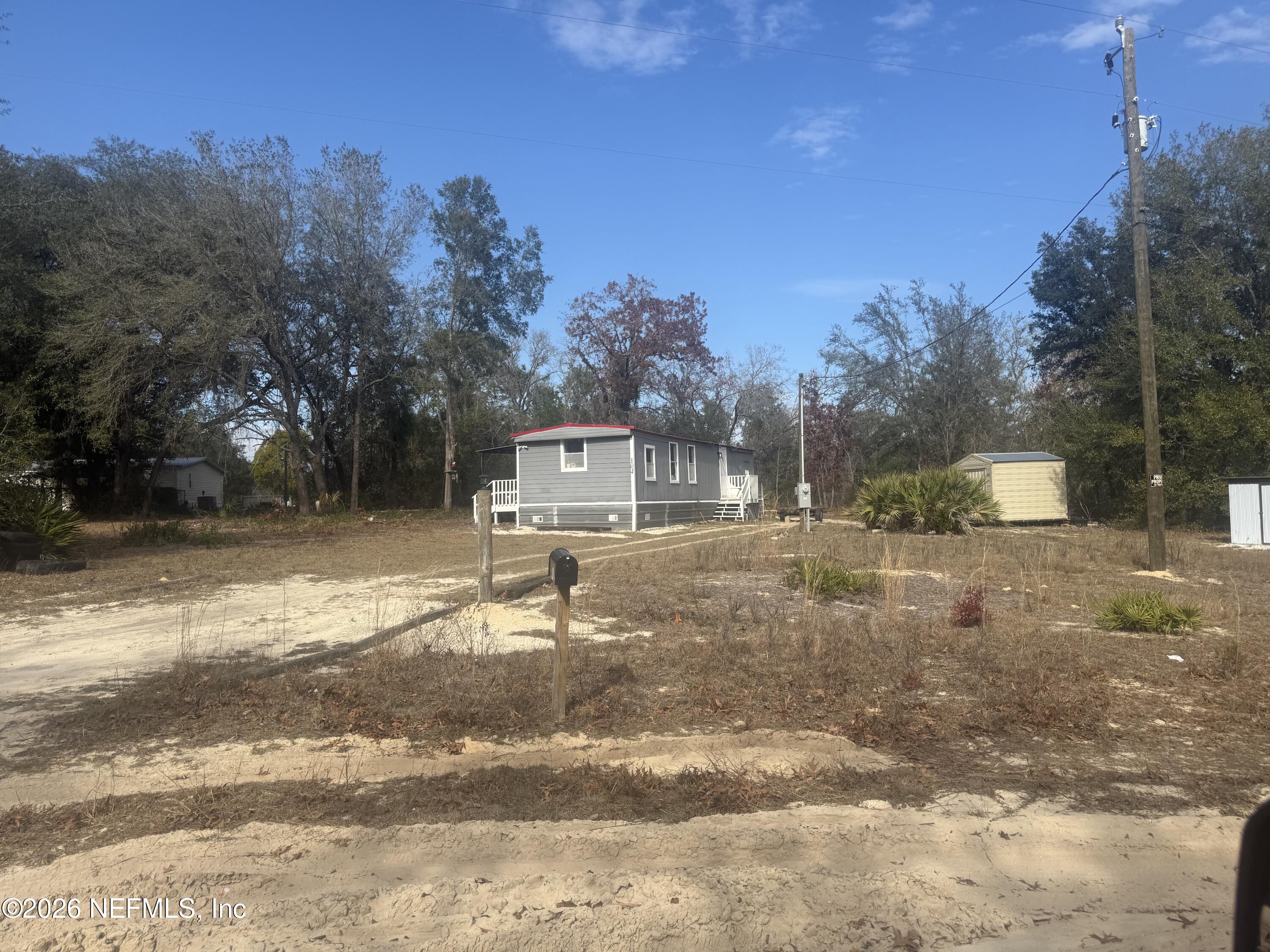 104 Churchill Street Interlachen, FL 32148 - Photo 2 of 24 a backyard of a house with table and chairs