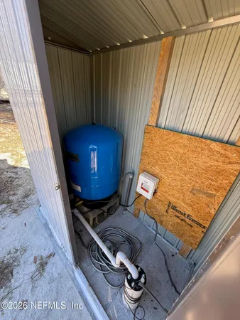 a view of dirt road with a building in the background